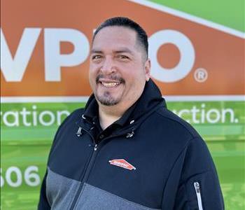 Pedro Velazquez standing in front of SERVPRO EV