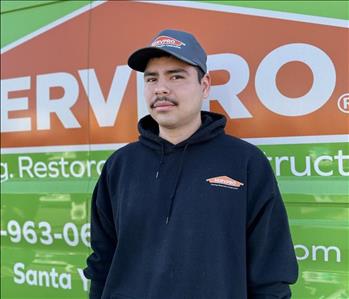 Male SERVPRO employee in front of green background