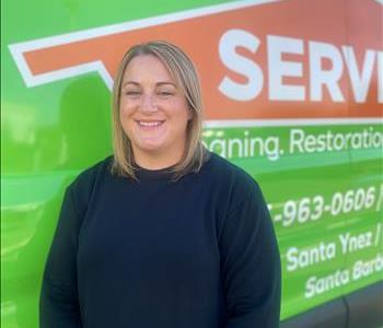 Katy Driscoll standing in front of SERVPRO EV
