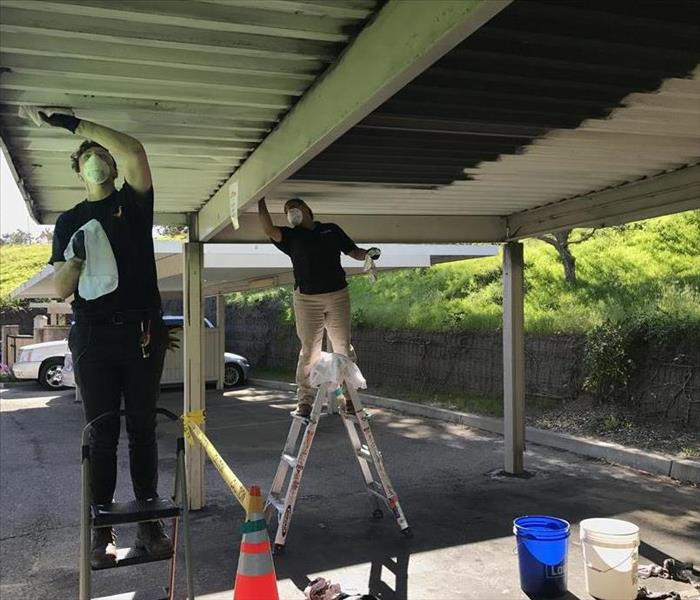 SERVPRO techs restoring a car port in Santa Barbara, CA.