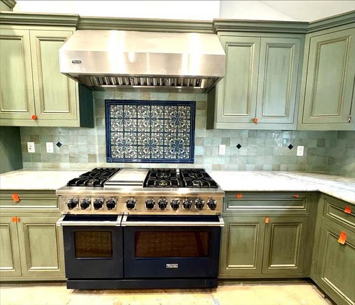 kitchen being remodeled with new cabinets and viking range